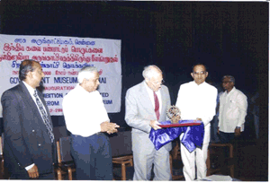 His Excellency, Rob Laurie A.M. handing over the artefacts to Thiru S. Ramakrishnan, I.A.S. Mr. Vinod Daniel (extreme left) and Thiru. R. Kannan, I.A.S., (extreme right) look on, 28-2-2000.